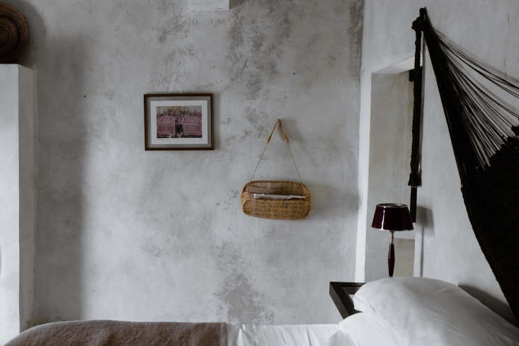  in a sparse but textural guest room, a woven basket doubles as hanging sh 19