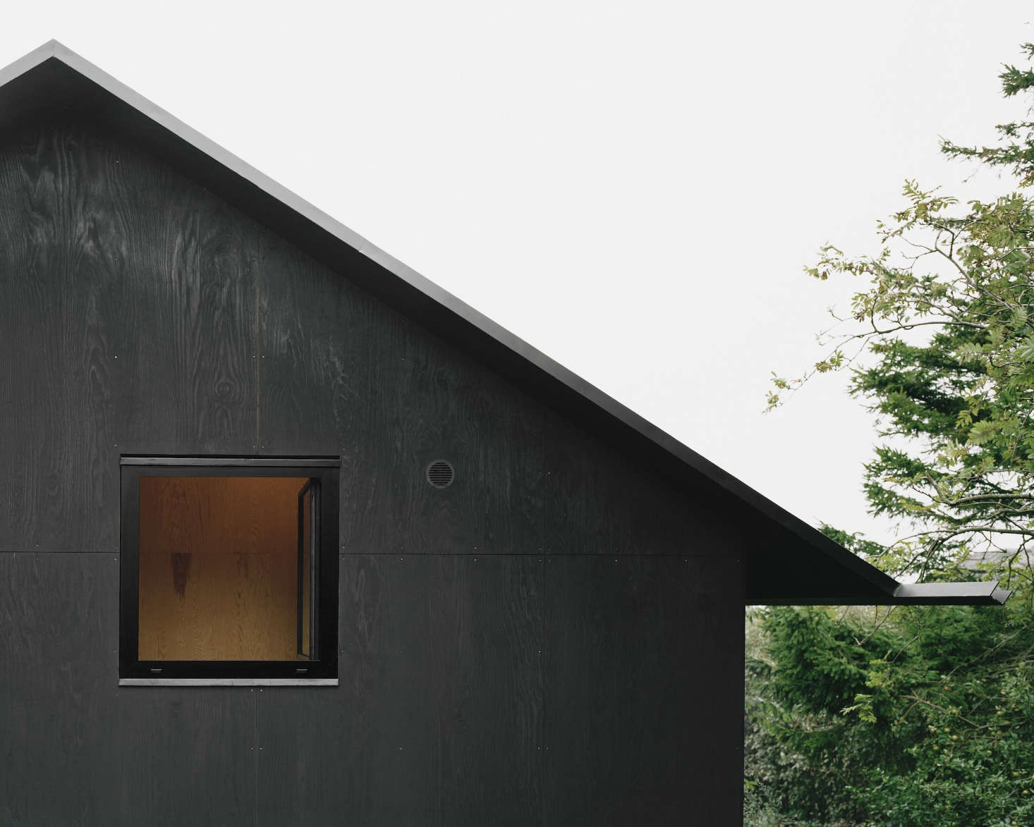 Sheets of plywood, ingeniously coated in tar, is waterproof and visually striking. See Architect Visit: Johannes Norlander in Sweden for more.