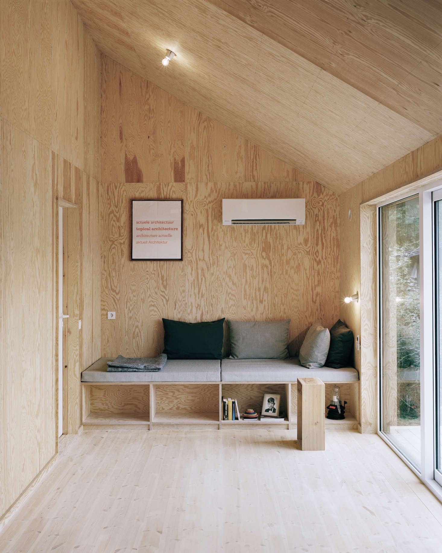 Plywood panels of various types and grains line the sitting room in Architect Visit: Johannes Norlander in Sweden.