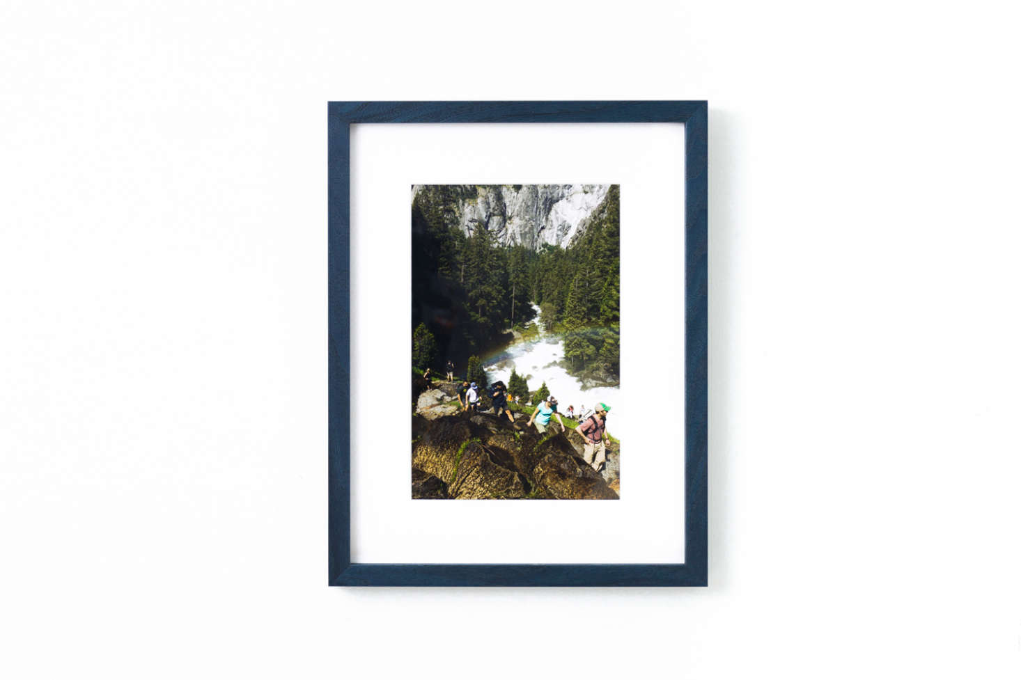 The Indigo Walnut Gallery Frame is a wood frame finished in deep blue; prices range depending on the article framed within available from Framebridge.