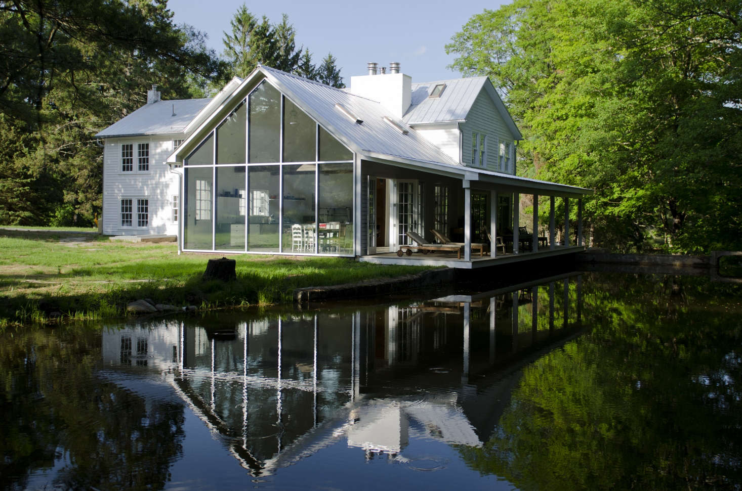 New (steel-framed skyscraper windows) and old (traditional rockers on the cantilevered front porch).
