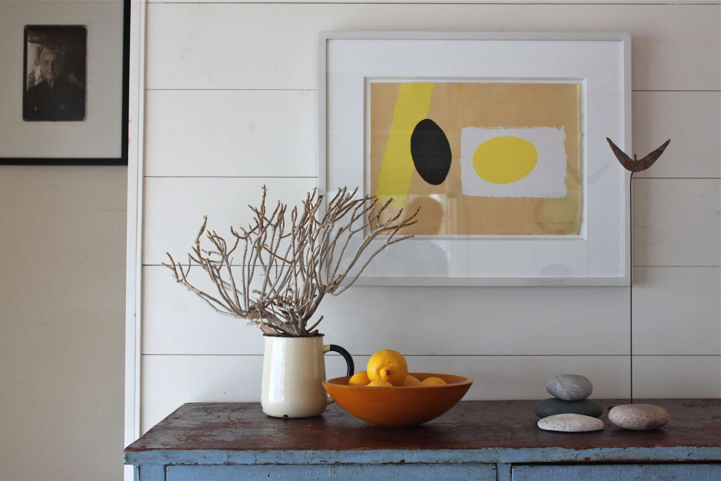 At Harbor Cottage in Maine, a silkscreen print by British artist Wilhelmina Barns-Graham hovers above the objects on the cabinet so that it feels like part of a larger composition. Photograph by Justine Hand.