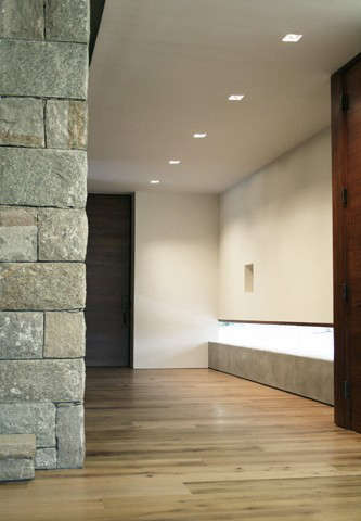 entry hall: a low concrete wall with frameless glass provides views to the gard 17