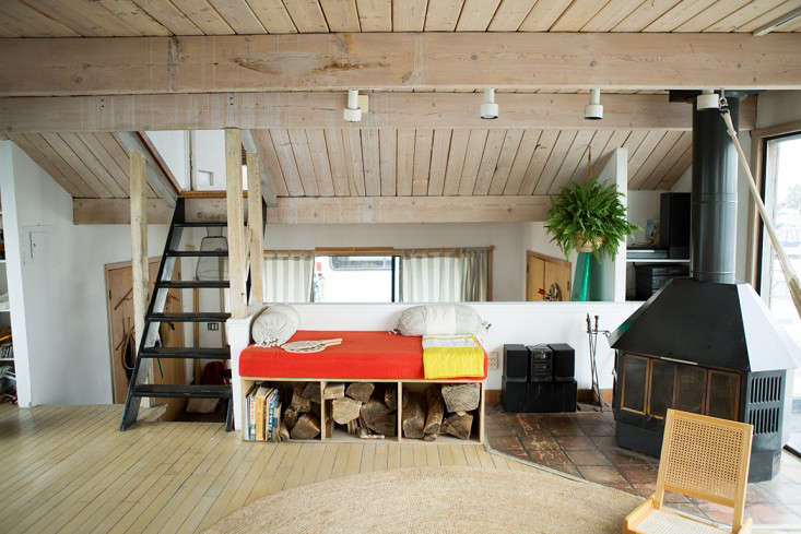 a built in daybed (with firewood storage) and a woodstove in the living room. 26