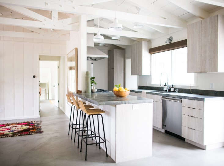 a bar counter topped with a large quartzite slab in designer lau 24