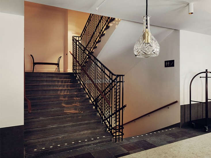 an open metal stair rail with a distinctive art nouveau pattern is decorative a 23