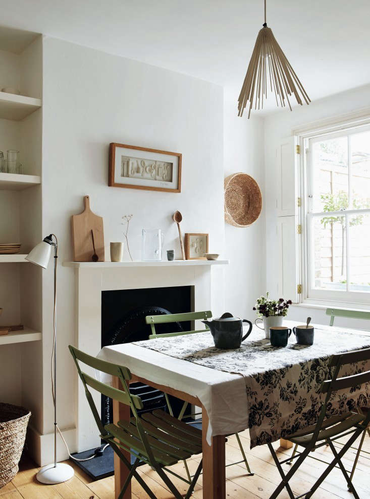 Interior shutters, rather than curtains, keep a petite dining room uncluttered. For more, see Required Reading: Beautifully Small.