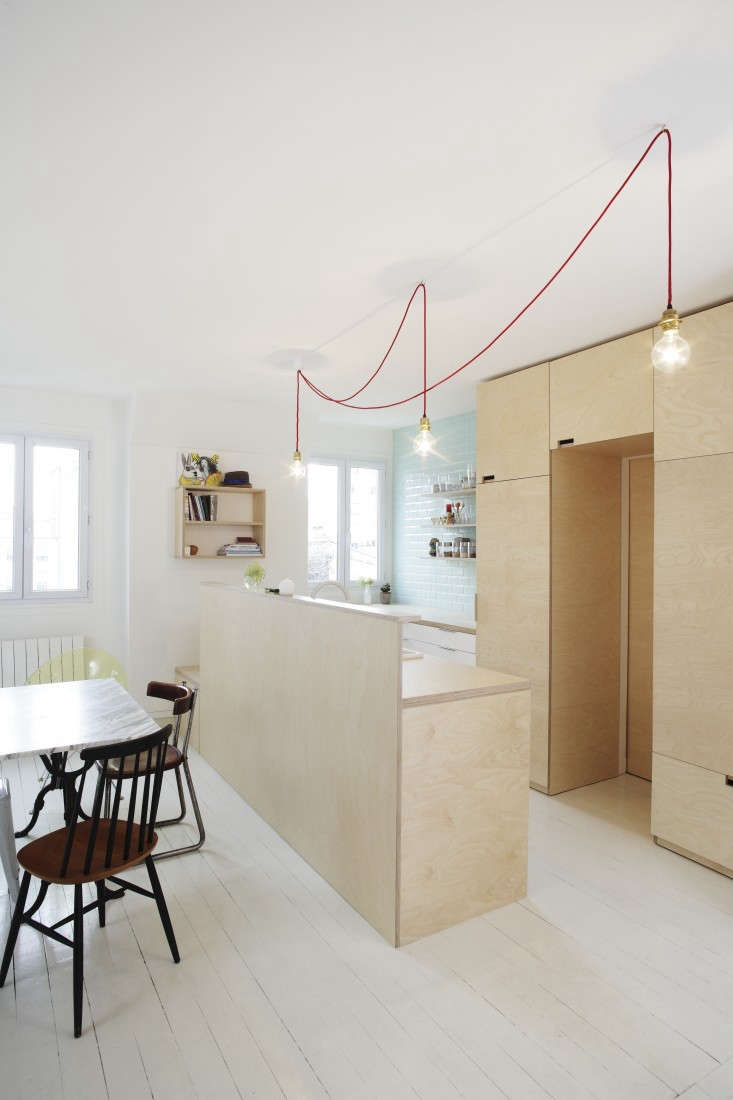 a small space plywood kitchen benefits from unobtrusive cutout cabinet pulls. s 17