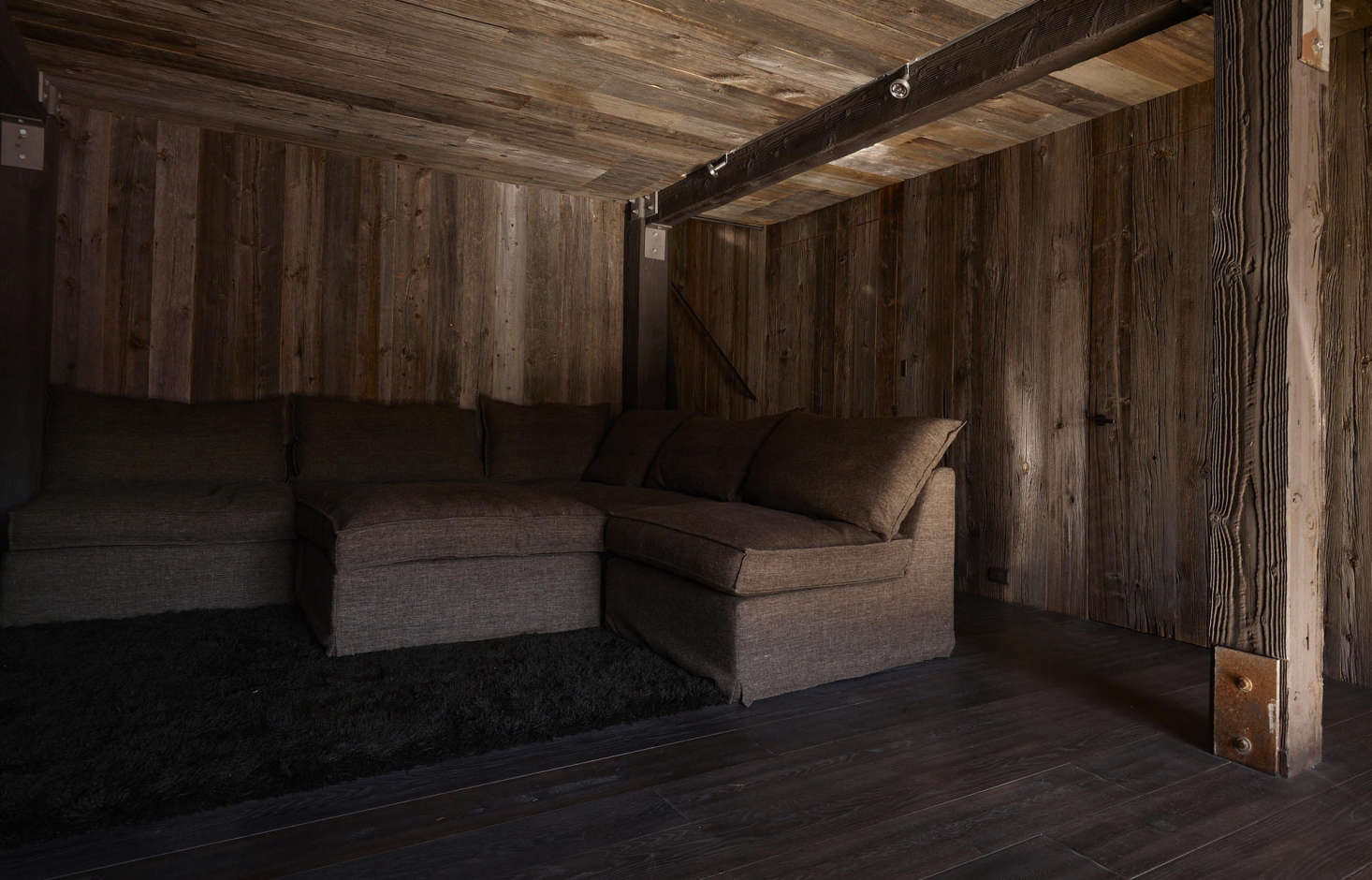 A lounging area with linen-covered sectional sofa.