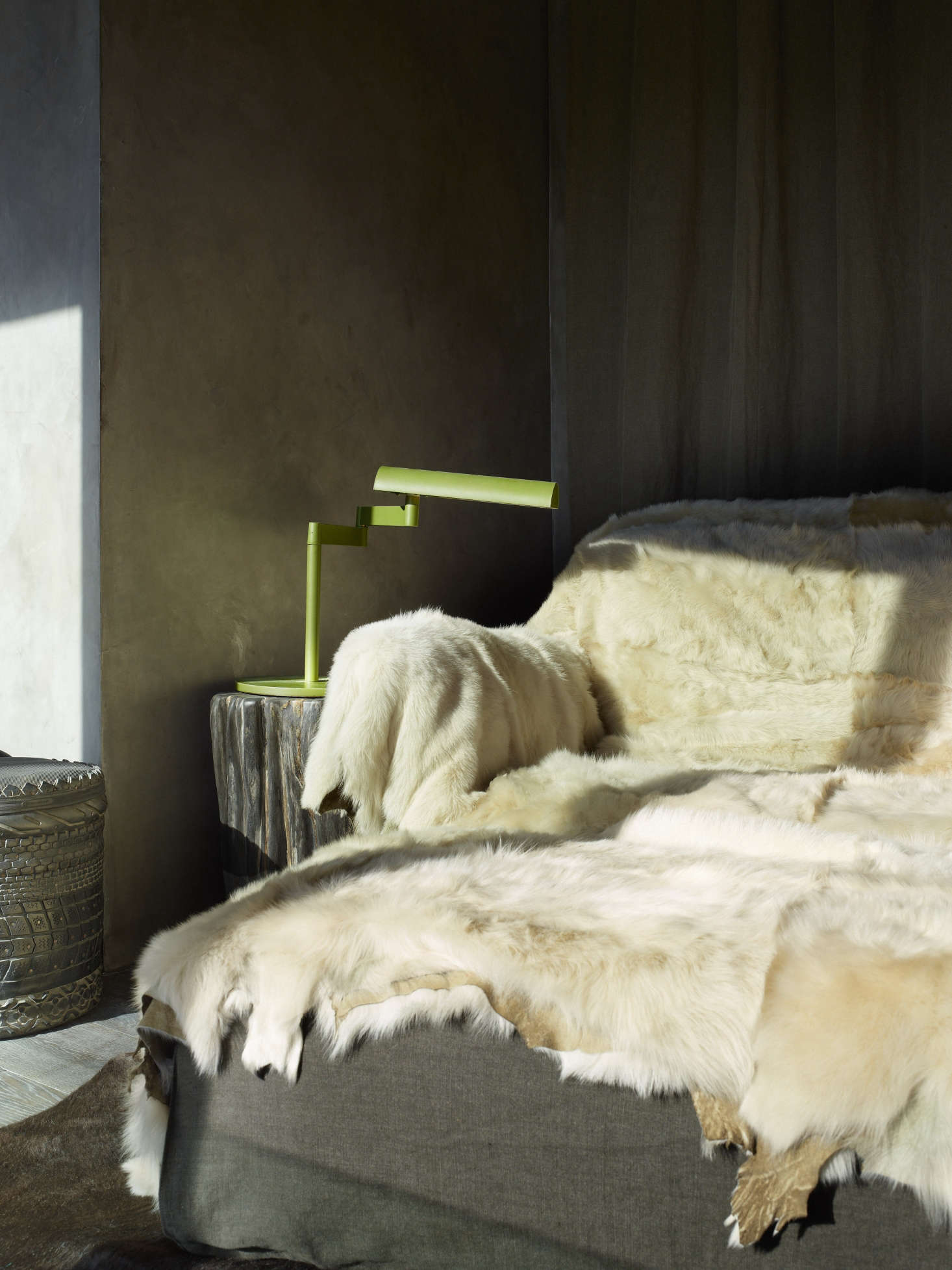 A reading chair draped in fur.