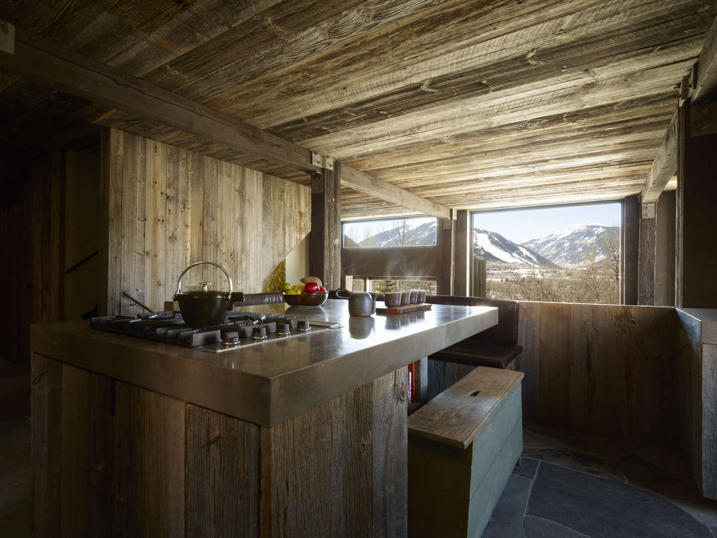 A compact kitchen with stone-topped island.