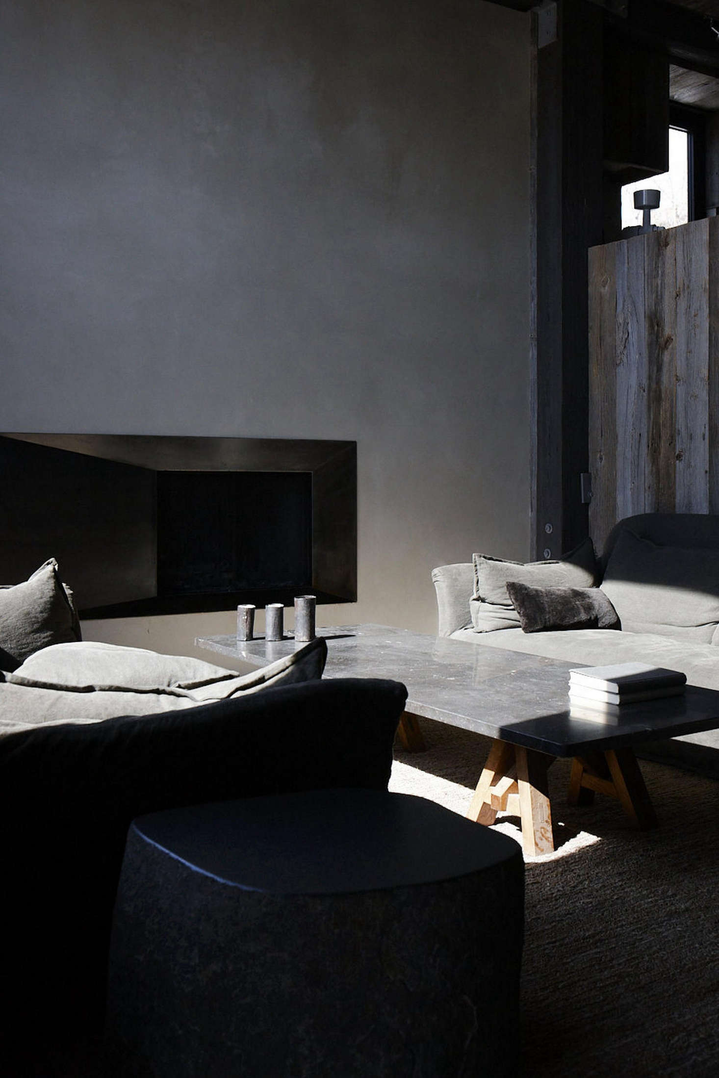 Stone gray linen compliments stone side tables and a slab coffee table.