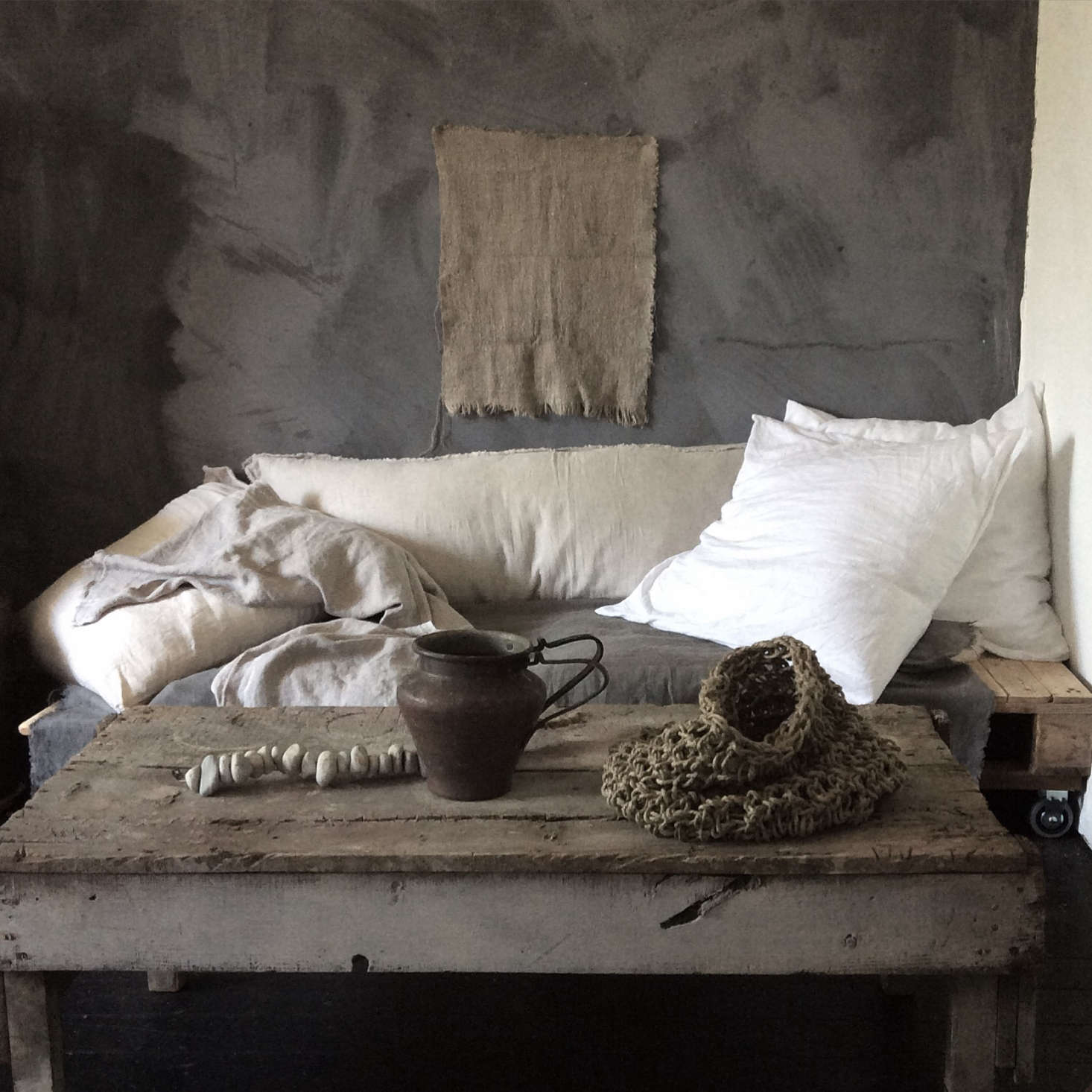 A strand of stones adorns a table of other sculptural elements at Mr. & Mrs. Charlie shop. See Vagabond Chic: Instagram Stars Mr. & Mrs. Charlie Launch a Shop.