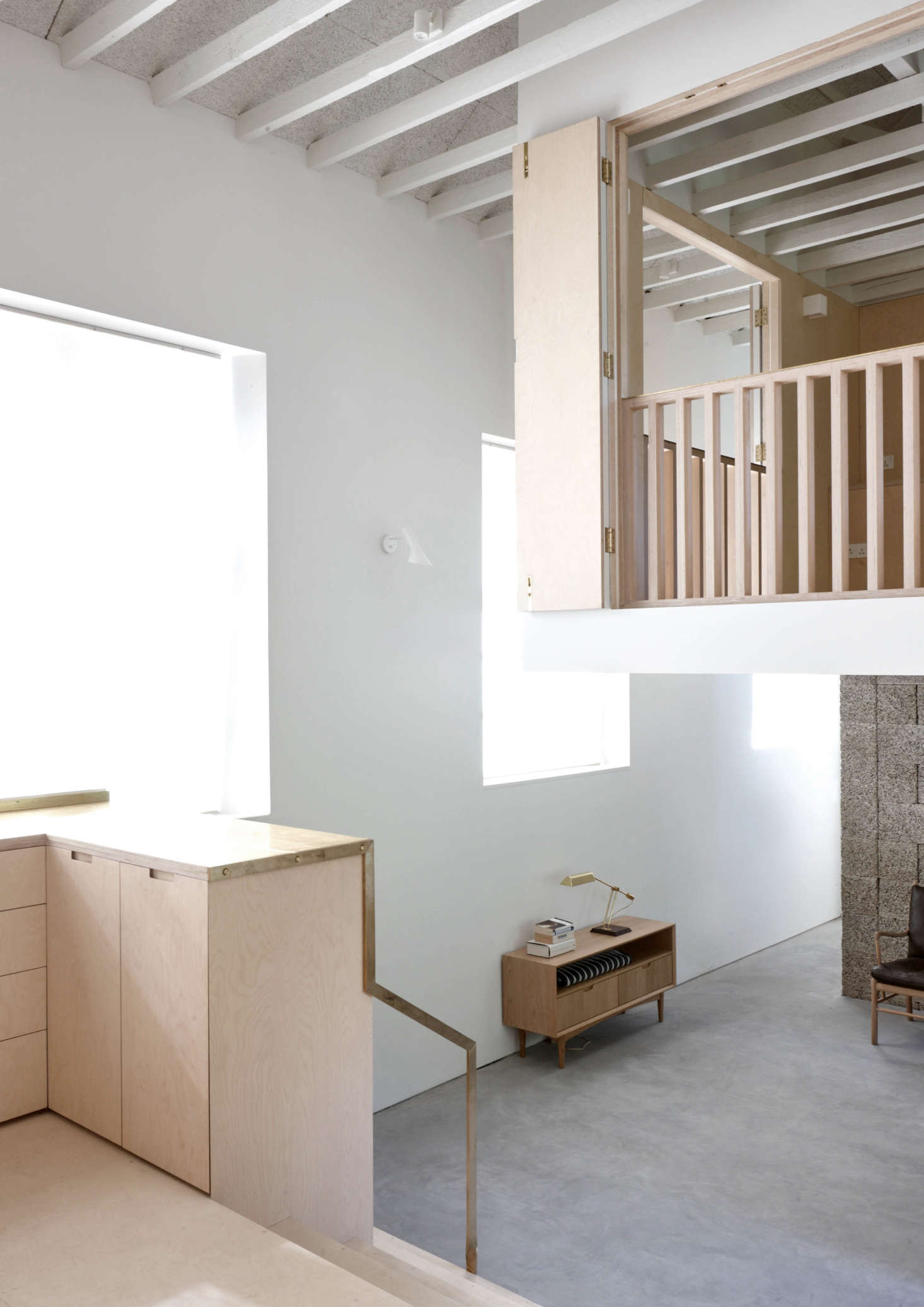 The brass counter edging becomes a minimalist stair rail.