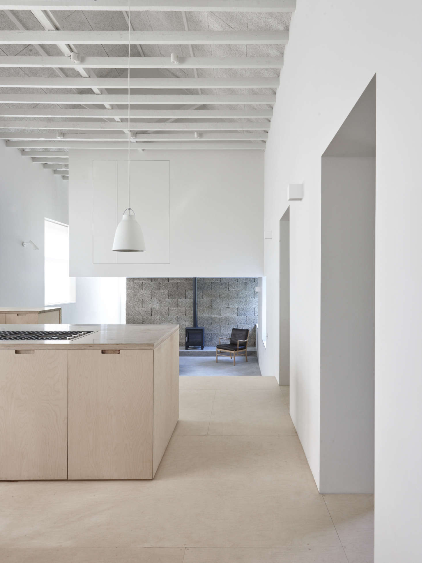 The ground floor features a dramatic double-height kitchen. It opens to the living room and clubhouse-like new second-story bedroom area that the architects carved out of gained and unused space—read on for trade secrets.