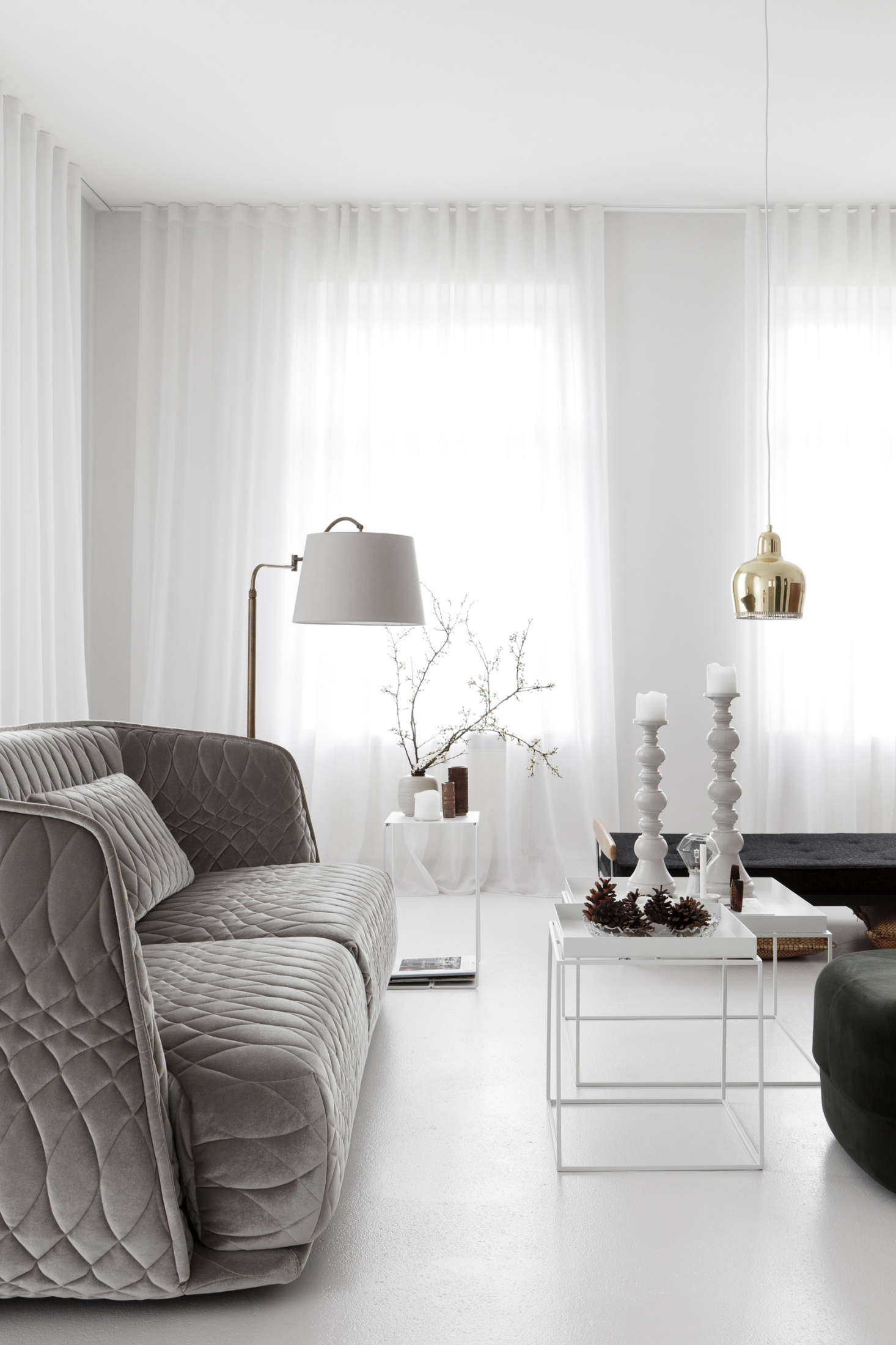 To maximize the open, airy feeling of this cozy apartment in Mainz, in western Germany, Lea Korzeczek and Matthias Hiller of Studio Oink employed the reflective power of white floors coupled with breezy, lightweight fabrics. Photograph courtesy of Studio Oink from Earthly and Ethereal: An Apartment Makeover by Studio Oink.