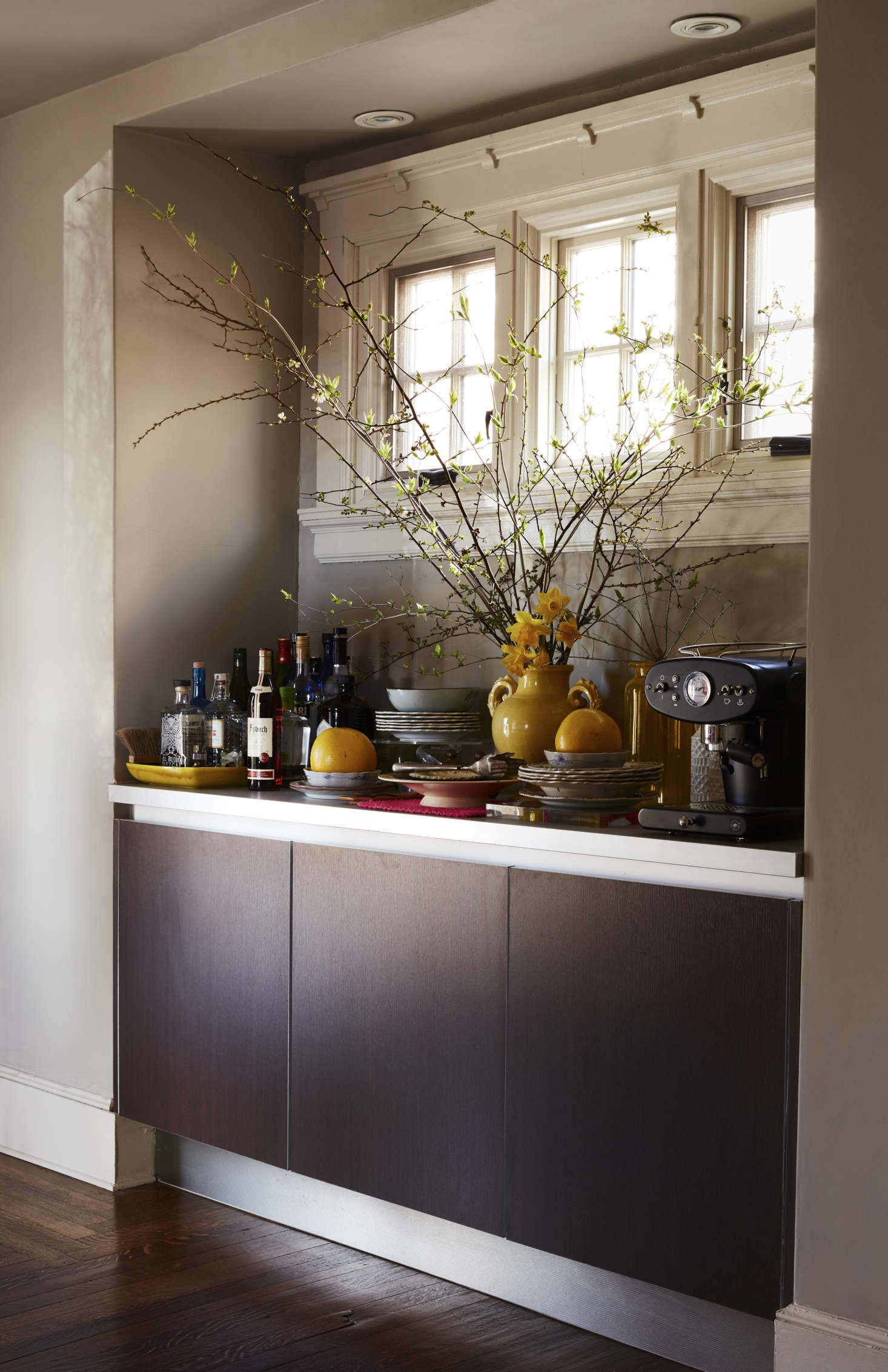 The dining room opens to the kitchen, so the couple linked the two by inserting a Poggenpohl sideboard and Ikea counter. Livia carried home the Illy coffeemaker from a trip to Italy—