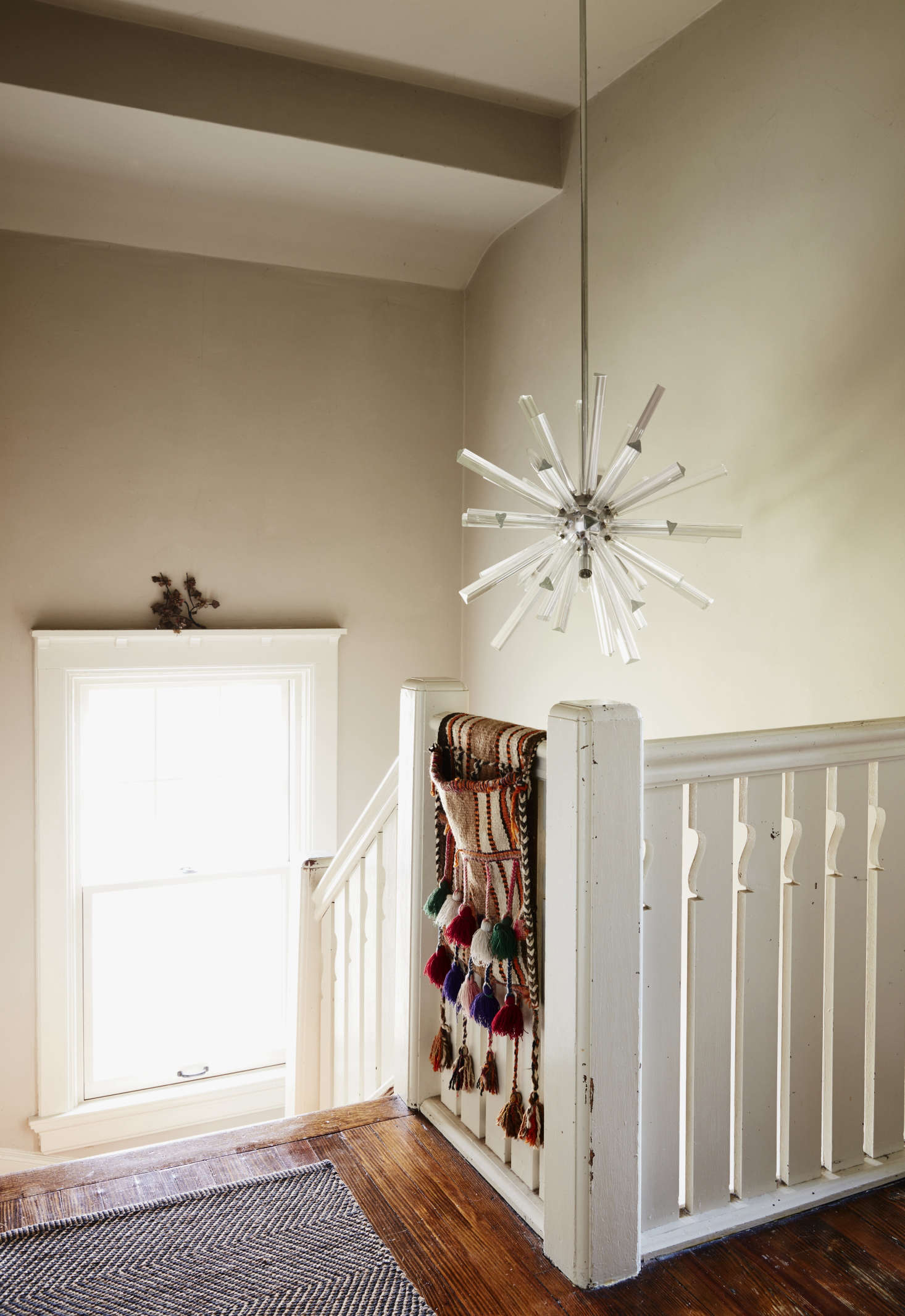 The upstairs landing is hung with a 60s Murano glass fixture that Danny got from a client who was getting rid of it. The tasseled saddlebag came from Nine Streets New York, one of Livia