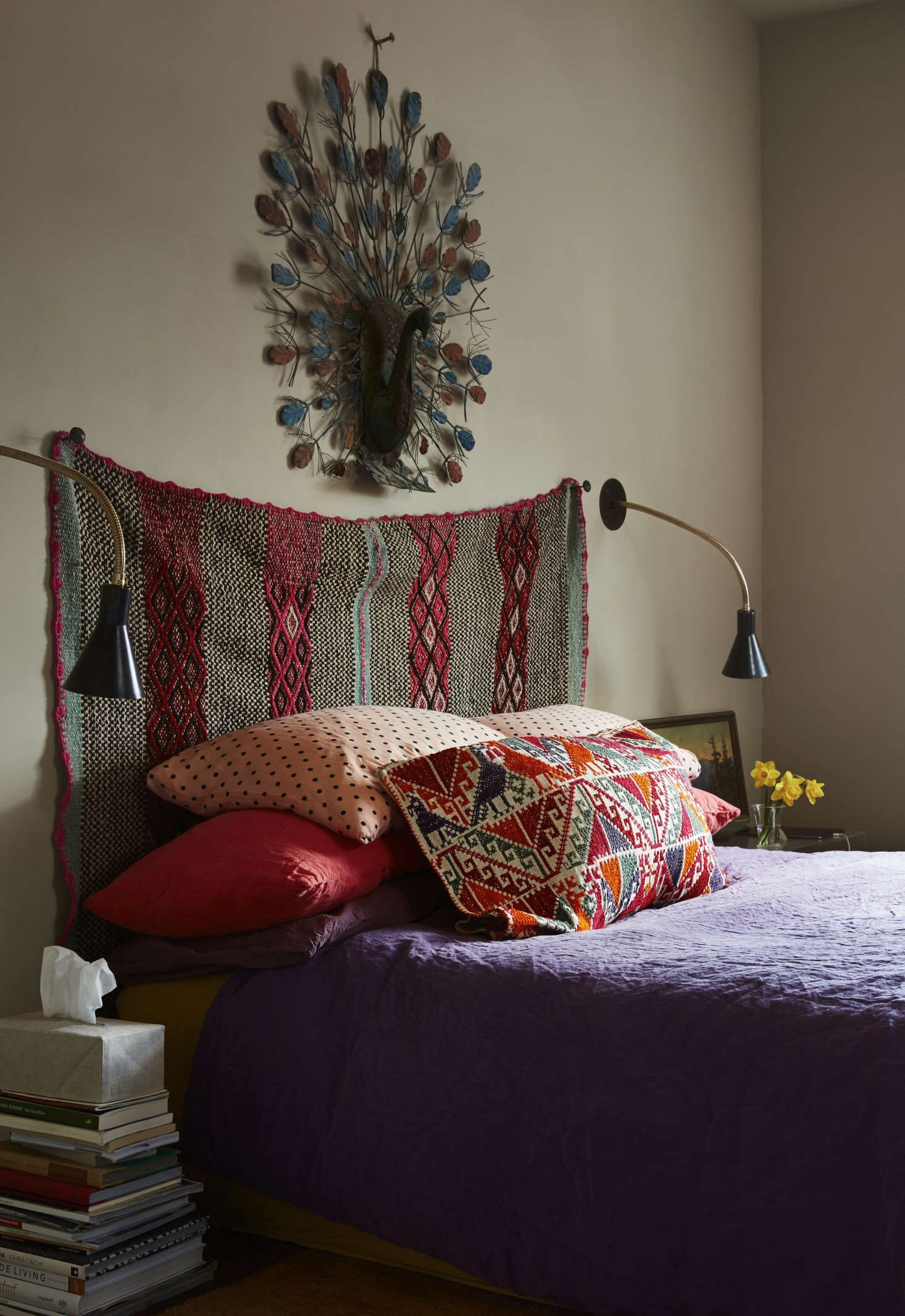 In the master bedroom, Livia hung an Andean frazada as the headboard. The blue metal ostrich over it is one of Livia