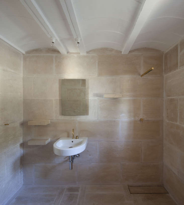 a serene bath stays cool with minimal fixtures and simple stone. see  22