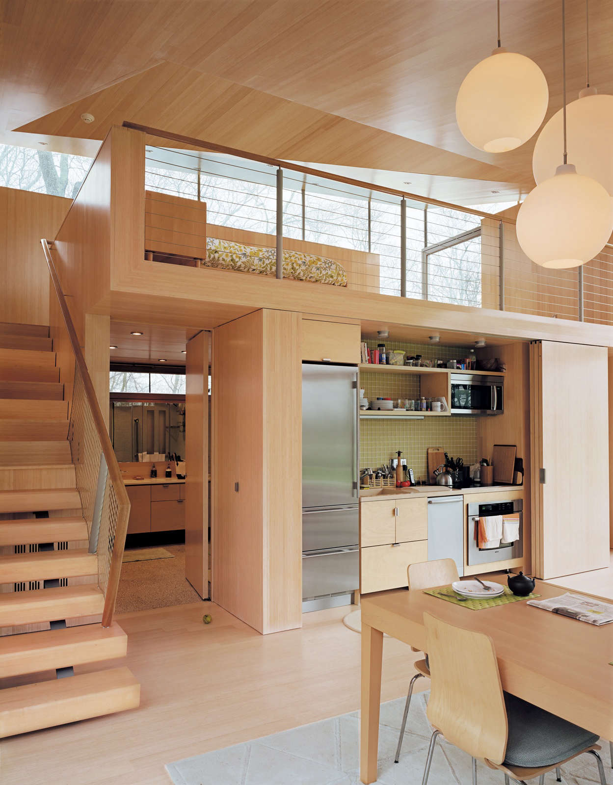 A small kitchen concealed behind folding doors in a project by Gray Organschi Architecture. Photograph by Mark Mahaney.