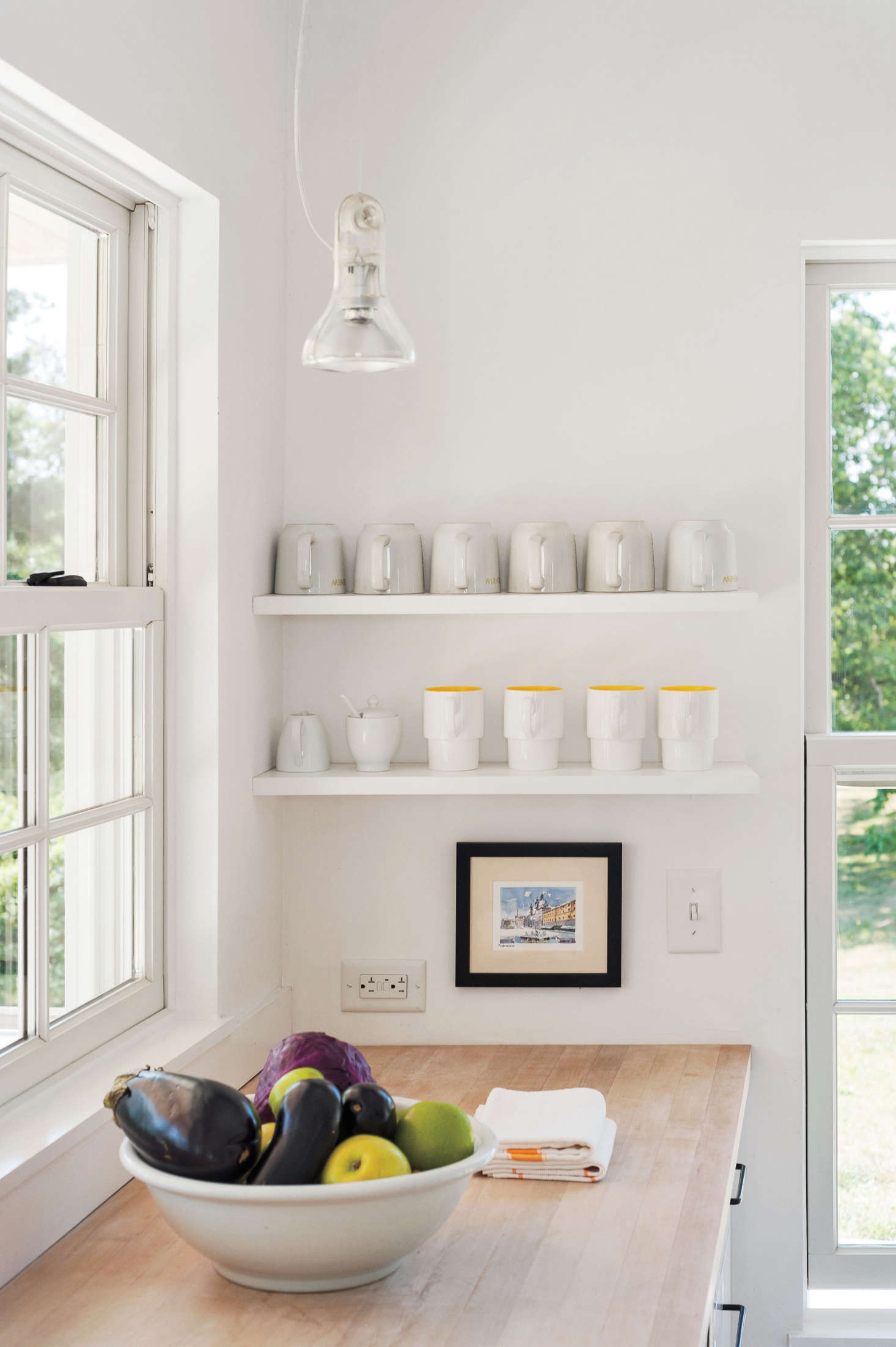 Mugs at the ready for renters; for more of this kitchen, see Kitchen of the Week: A Streamlined Cape Cod Classic. Photograph by Matthew Williams for Remodelista.