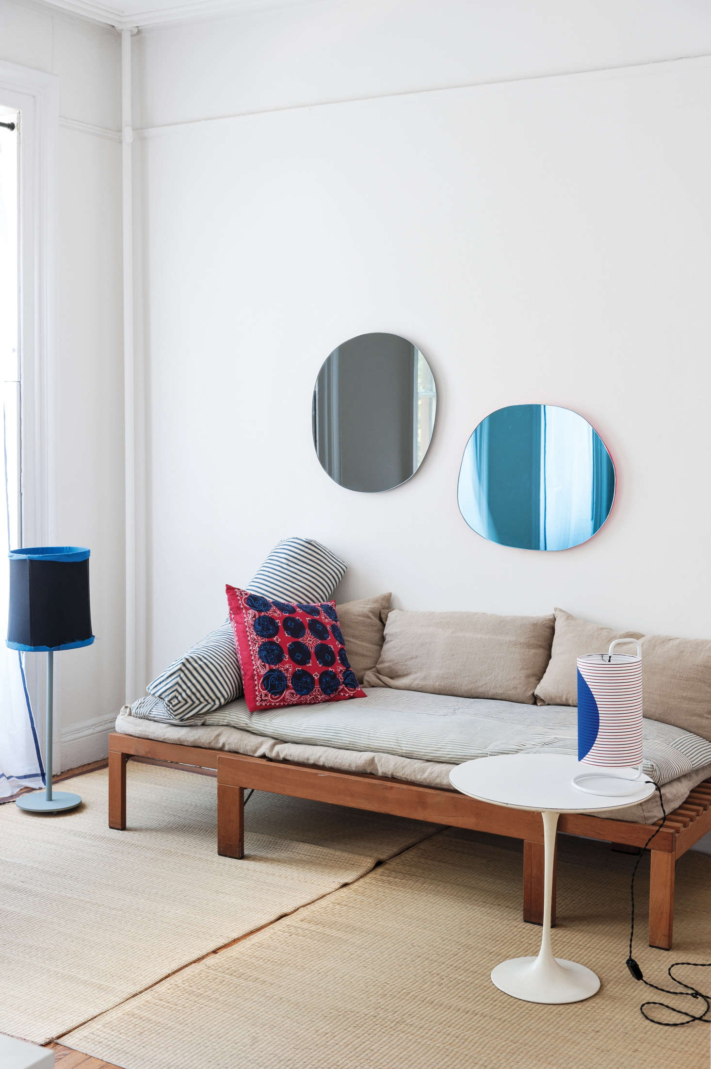 Designer Corinne Gilbert uses low-slung pieces to create an open feel in her living room. Also, notice that the mirrors are hung low so that they 