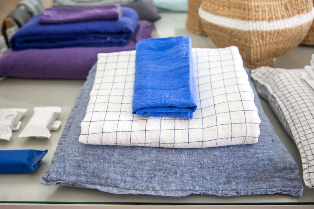 blue linen pillow, duvet, and napkin in lost & found modern home store in s 31