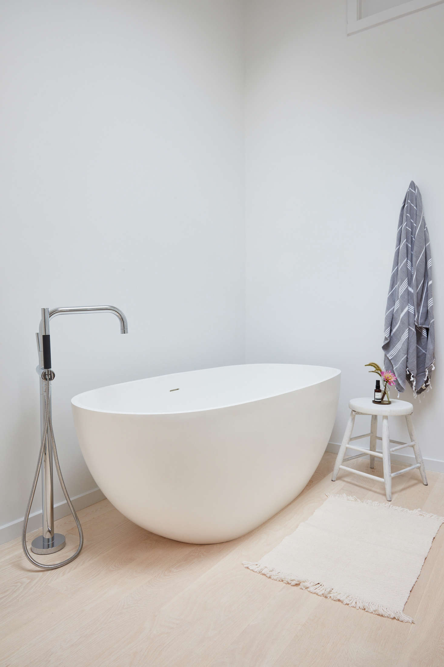 Also in the master bathroom, the ideal rejuvenation spot: a freestanding soaking tub from Signature Hardware is paired with a faucet from Kohler
