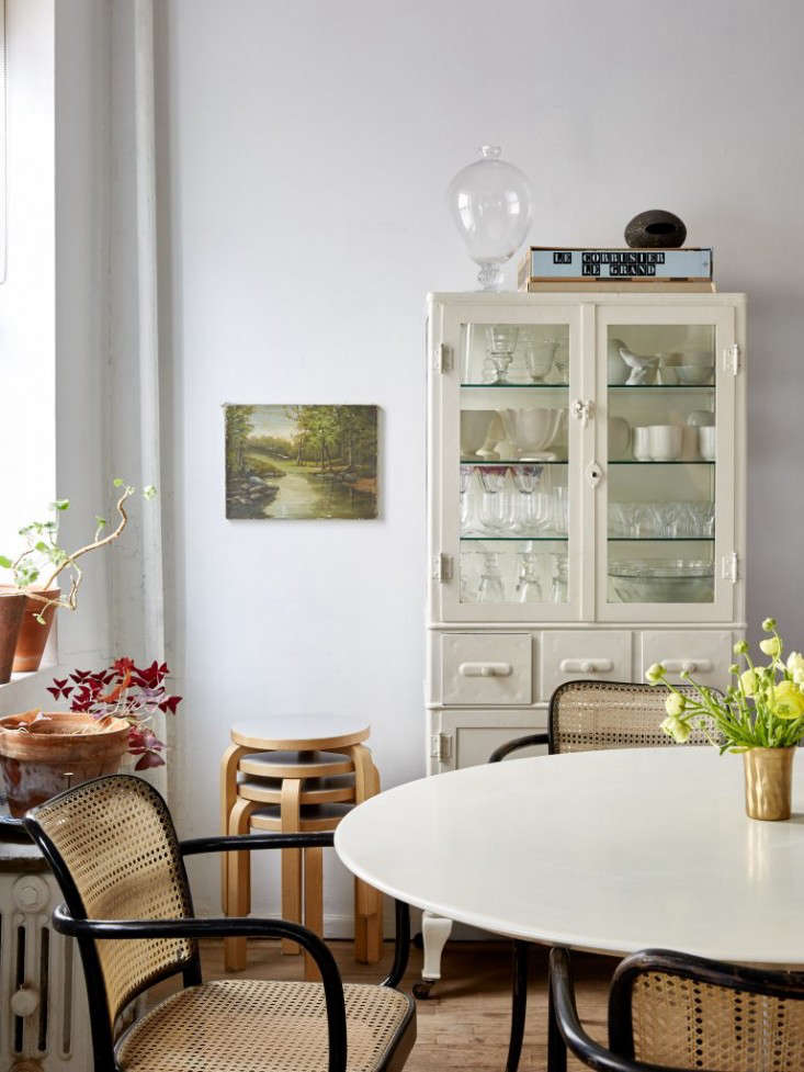 Efficient vertical storage, including stacking stools and a tall hutch, as seen in Small-Space Solutions: Affordable Tips from an NYC Creative Couple.
