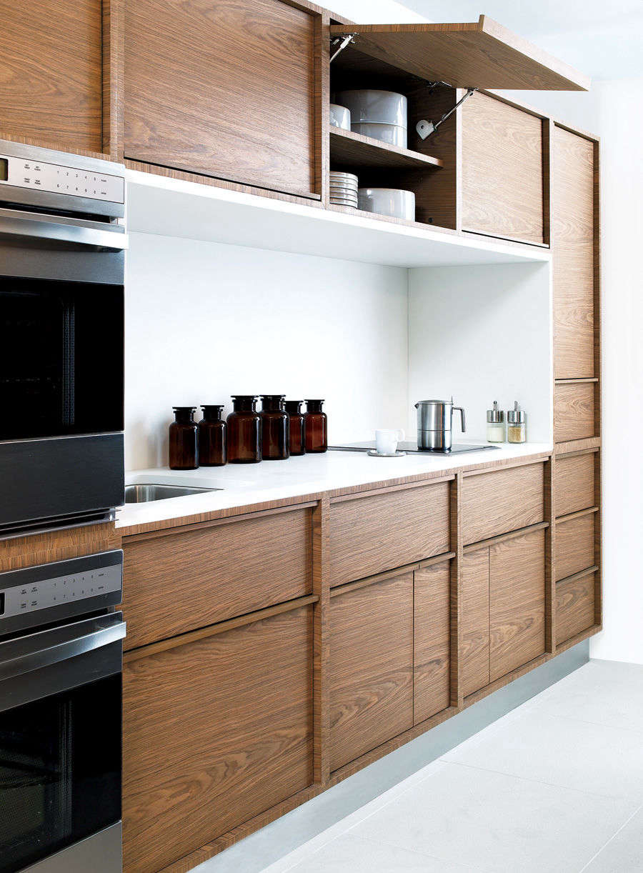 Garage door hinges for upper cabinets allow for easy access in a kitchen by San Francisco–based Nilus Designs for DWR. (Unfortunately, they are no longer available.)