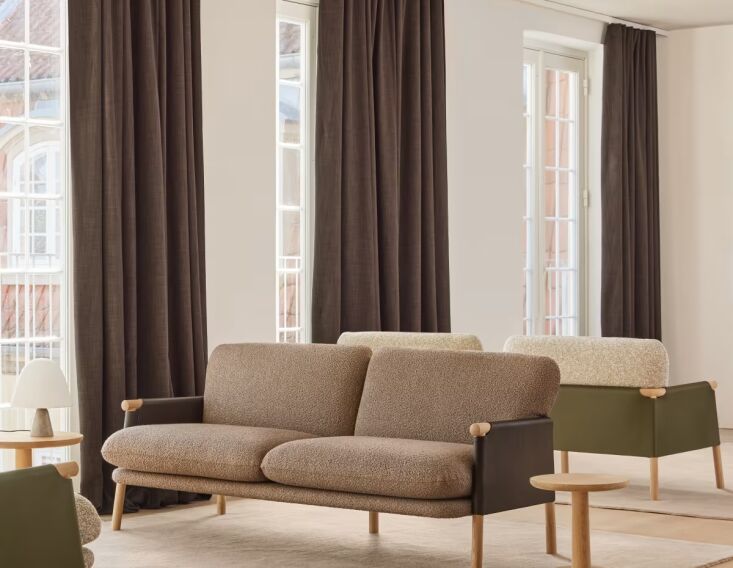 from swedish designer monica förster, the savannah sofa is a wooden frame with 22