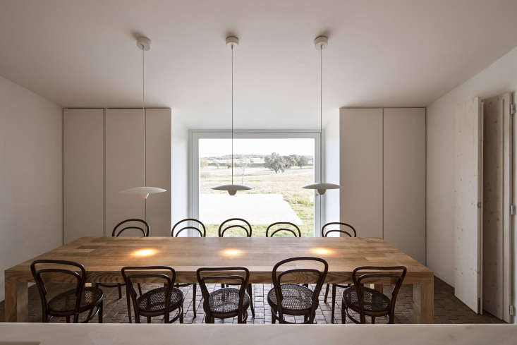 the farmhouse table is surrounded by a suite of vintage era chairs by mich 21