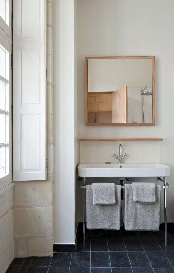 chalky limestone walls from the \1\2th century frame a bathroom in the fon 18