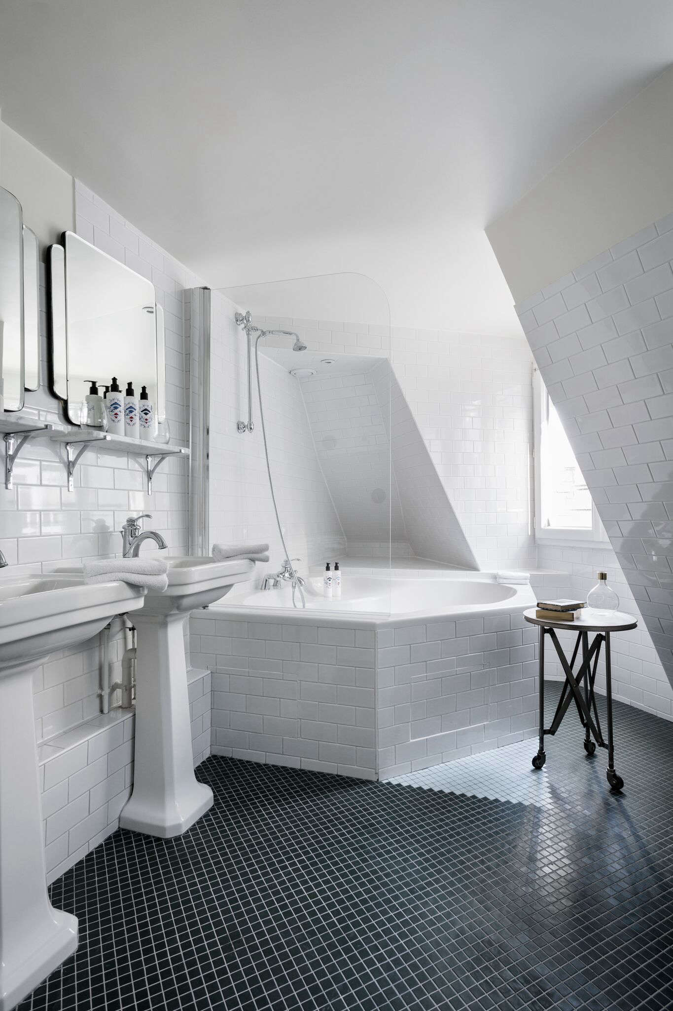 tucked under the mansard roof on the top floor, a corner tub with a view. 26