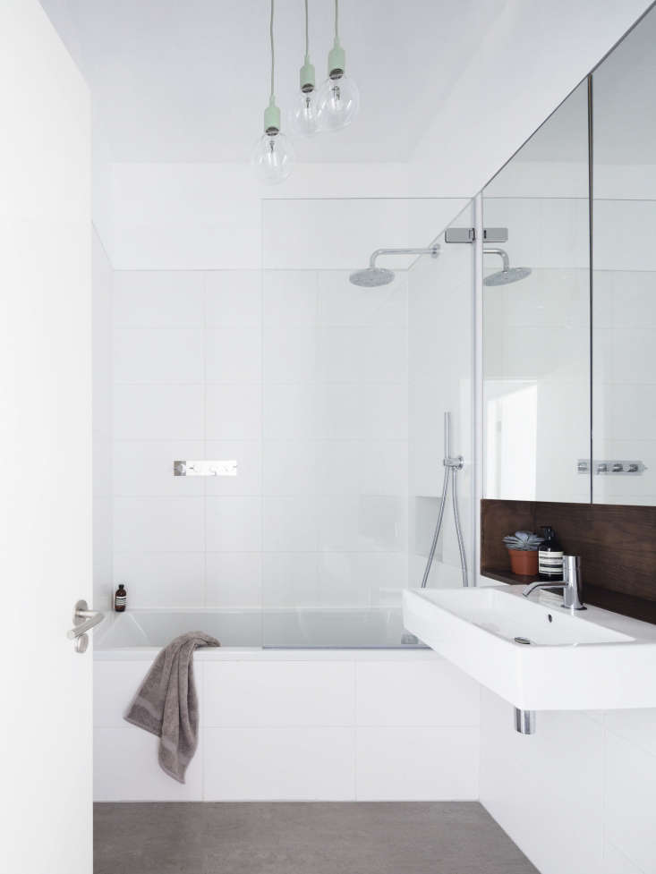 in the family bath, johnston offset white tiles with a stone floor (fired earth 28