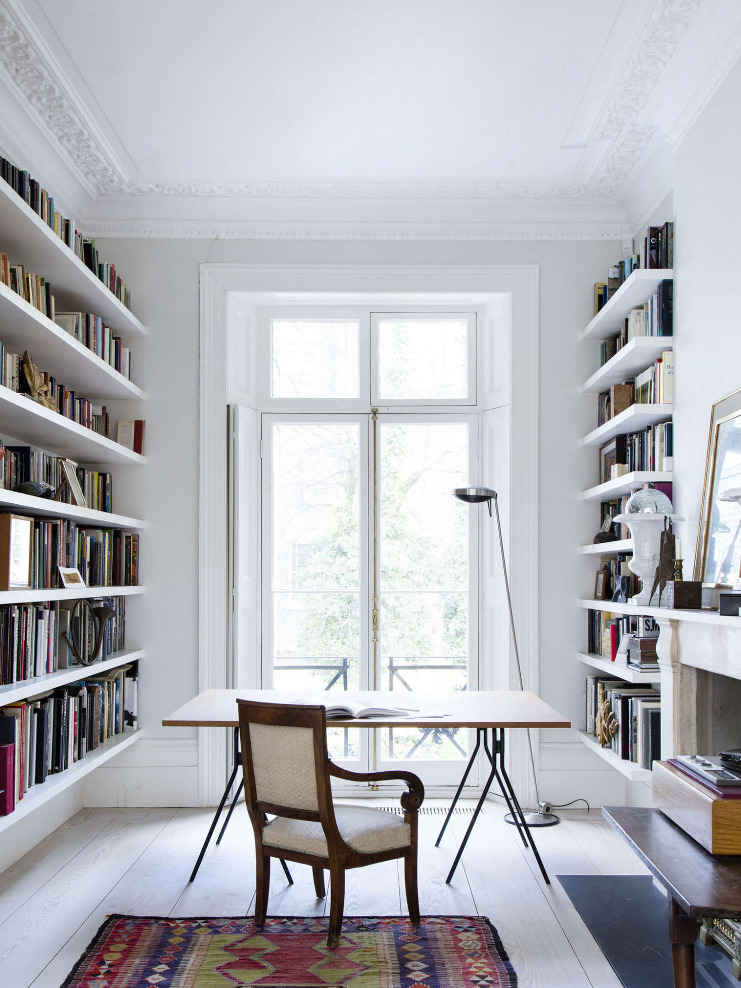 The desk is flanked by rows of books in this Notting Hill townhouse study. Photograph by Rory Gardiner, styling by Emma Lynn Archer, from A Notting Hill Townhouse Artfully Transformed by Sadie Snelson.