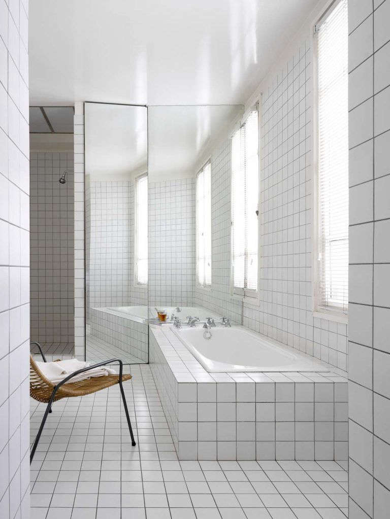 An artful built-in bath, surrounded in the same tile as the floor and walls, in A Minimalist Parisian Loft. Photograph from RL Interior Architecture.