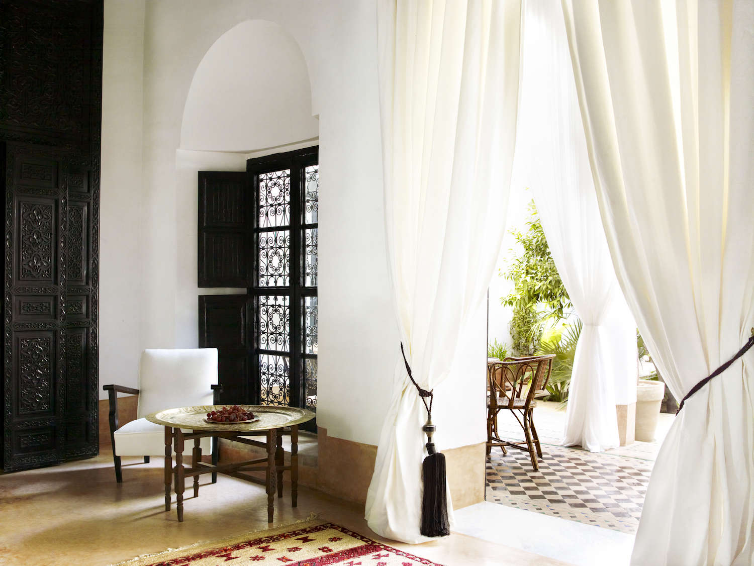 white curtains riad hotel marrakech black filigree windows 23