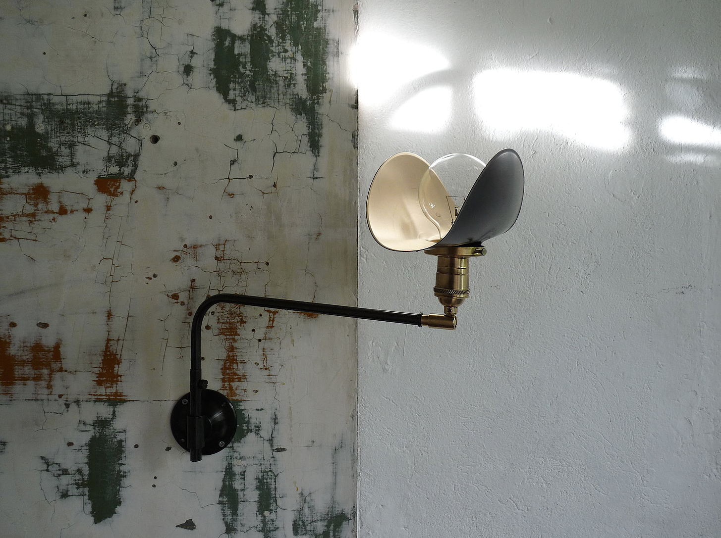 The petite Marianne Swing Wall Lamp has a brass switch socket; €4 ($45data-src=