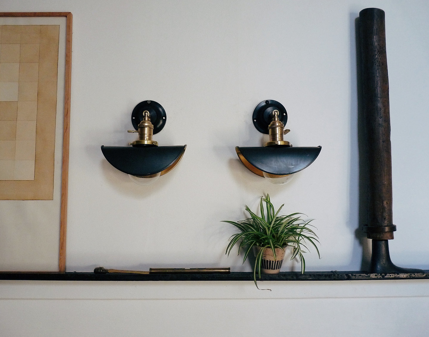 The Untel Sconce can swivel to any angle and is fully customizable with a variety of shades. Shown here: black patina bent steel; €0 ($5) each, €459 ($487) for the pair.