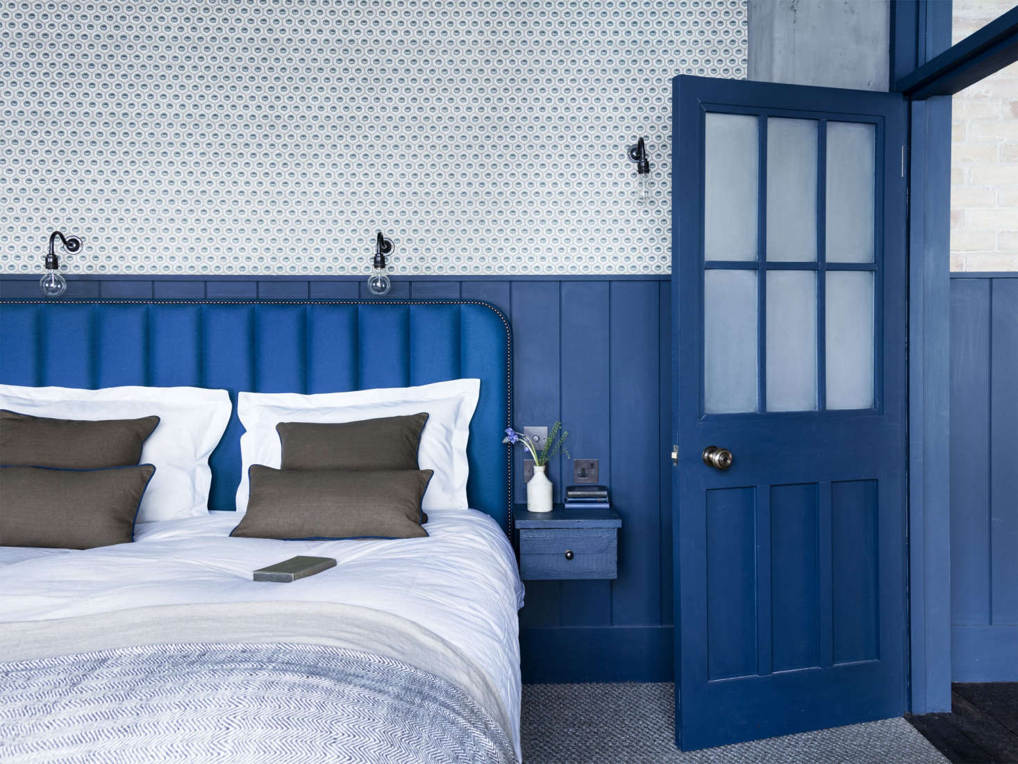 Pattern on pattern and layers of blue in the bedroom. Photograph by Rory Gardener from A “Modern Victorian” Loft in London by Mark Lewis.