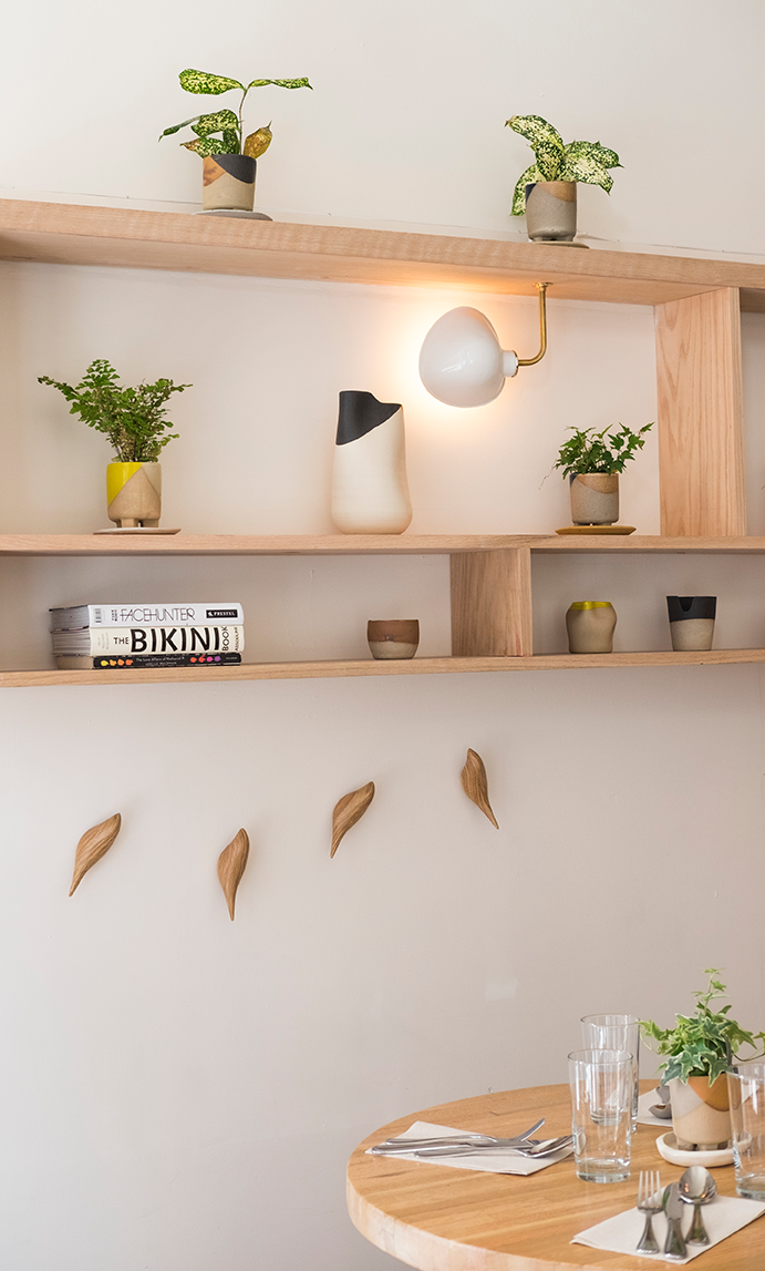 hand carved birds double as coat hooks. the ceramic and brass light is aciar&am 20