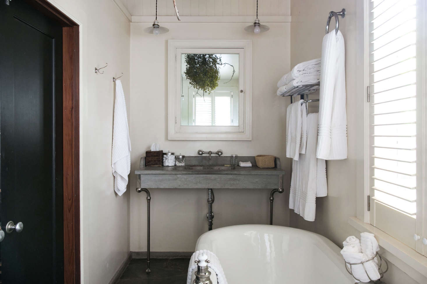A cast concrete sink looks almost delicate in an en suite bathroom at Manka