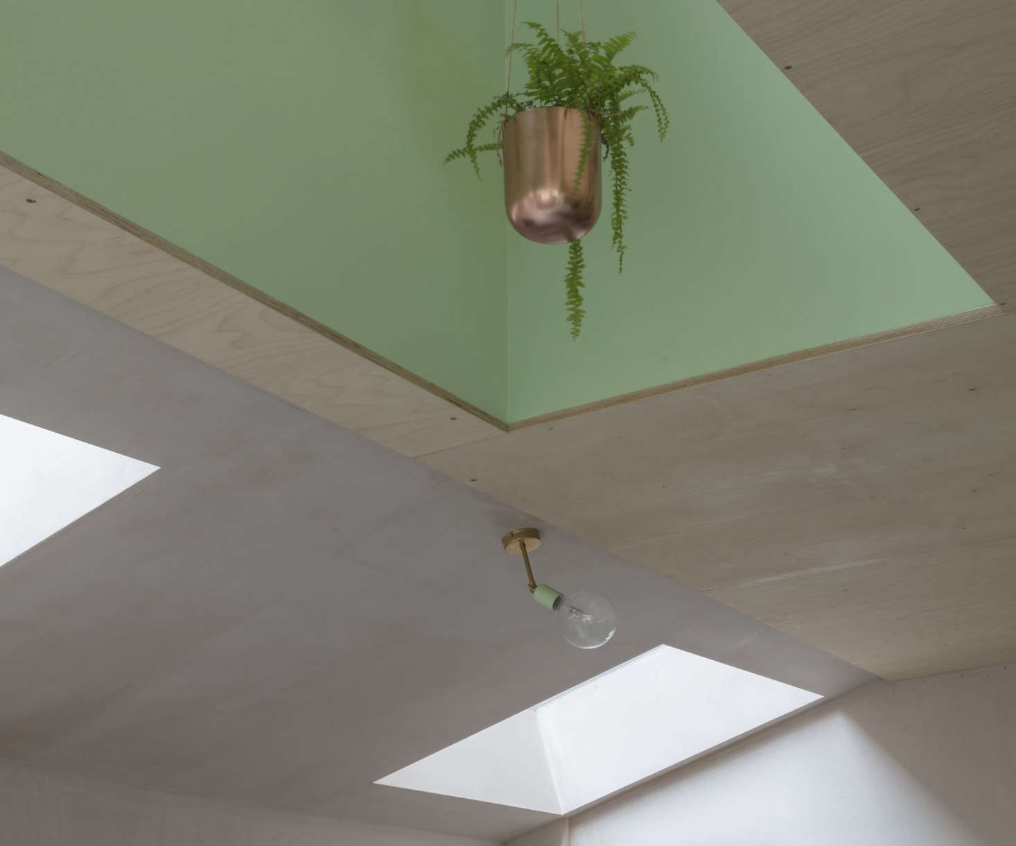 The family hung a series of copper planters in the recess over the island. For a similar design, consider Bloomingville