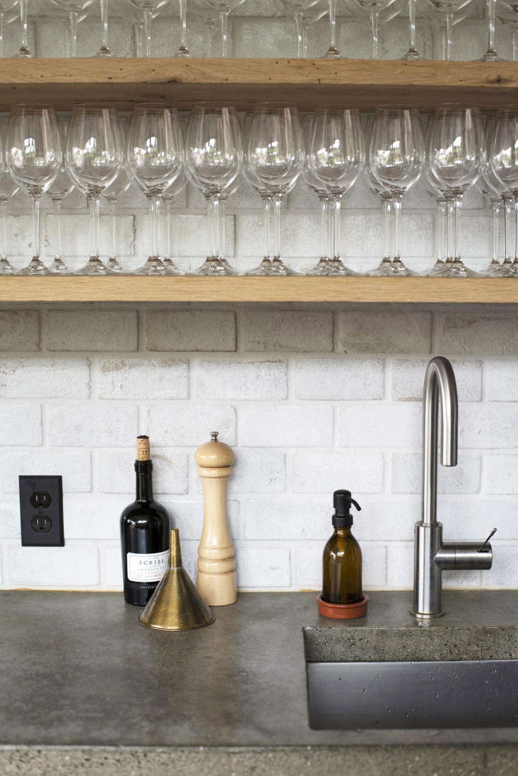 a small prep sink with a kwc ono single lever faucet. a brass funnel and a peug 29