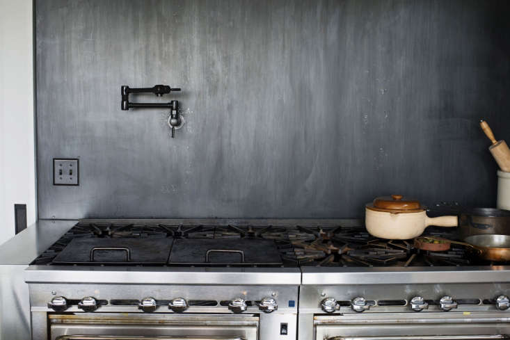a backsplash made of blackened, cold rolled steel and a brizo (6\28\20lf) euro 21
