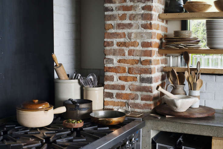 a collection of copper pots, terra cotta cookware, and dozens of wooden spoons 22