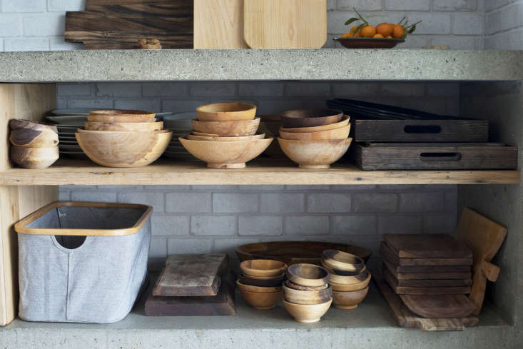 stacks of bowls made by artist jess hirsh are stored on lower shelves. 26
