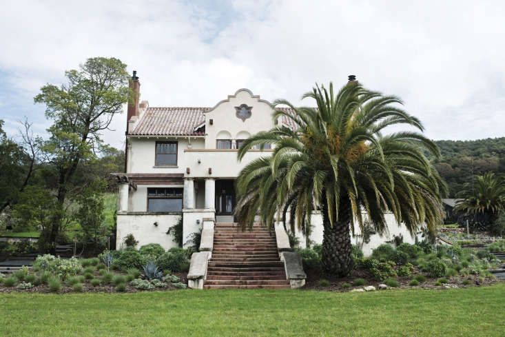 the hacienda is centered on the property and surrounded by vineyards, a grass 17